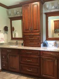 bath cabinets mirrors and toilet topper cabinets in kemper cabinetry s herrington cherry whiskey black c kitchen and bath showroom kitchen sale countertops bath cabinets mirrors and toilet
