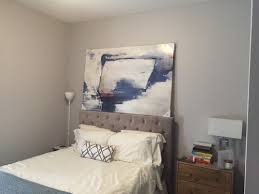 A plain piece of plywood is inexpensive and easy to install. Art Above Bed