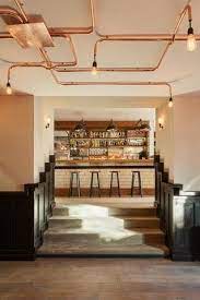 afbeeldingsresultaat voor verlichting koperen buizen plafond cafe interieurs restaurant interieur plafondontwerp
