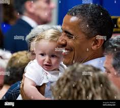 President Barack Obama holds nine-month-old Nathan Maxwell Johnson of  Youngstown, Ohio, following his Betting