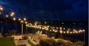 They are strings of hanging light globes/bulbs hung from to two different structures (posts, beams, poles, etc). Festoon Lights What Is It Its Usage And Styles