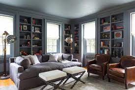I have a dark charcoal colored couch and a cream/white arm chair and ottoman. The Library Boasts Charcoal Walls A Custom Made Grey Lounge Sofa And Two Cognac Leather Club Chairs With Nailhead Detail Blue Rooms Chic Living Room Home