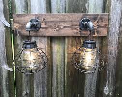 Ideal for a rustic farmhouse or nautical bathroom theme, this vanity light captures the eye with its authentic long gold finish bath vanity light: Mason Jar Light Fixture Industrial Light Light Rustic Etsy Rustic Bathroom Lighting Mason Jar Light Fixture Vanity Light Fixtures