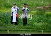 Kevin Chappell, right, talks with his caddie as he prepares to hit out ...