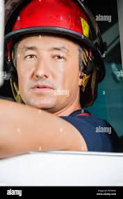 Fire men sitting in fire truck hi-res stock photography and images