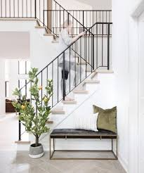 A townhouse with a wood staircase. Entryway Staircase Decor Staircase Decor Ideas Farmhouse Staircase Decor