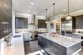 The floors also echo the mountainside with its light travertine tiling, as does the backsplash in varying small cuts of grey and white stone. Modern Gray Kitchen Features Dark Gray Flat Front Cabinets Paired Stock Photo Picture And Royalty Free Image Image 70177674