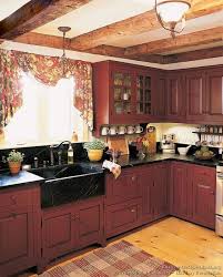 A Rustic Country Kitchen In The Early American Style Red Kitchen Cabinets Rustic Kitchen Rustic Country Kitchen Decor