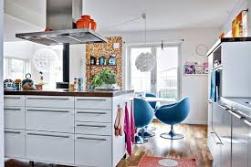 Any colorful grouping looks deliberate when you display it on shelves painted the same white shade as the walls. Colorful Home Decor In Sweden