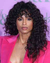 Wavy curly hair is left long and cut to form side swept fringe. Best Fringe Hairstyles For 2021 How To Pull Off A Fringe Haircut