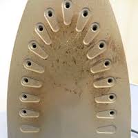 Place two folded white and green towels side by side. The Real Diy To Clean A Burnt Iron