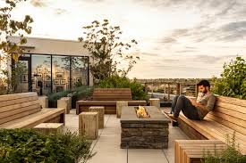 Outdoor patio ideas don't get more gorgeous than these! A Fire Pit Anchor In A Gathering Space Rooftop Design Rooftop Patio Design Rooftop Terrace Design
