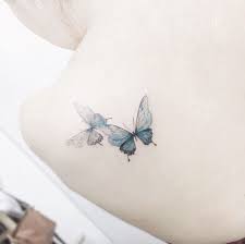 Playful Butterfly Tattoos On Back Shoulder By Tattooist Flower Elegant Tattoos Butterfly Back Tattoo Stylish Tattoo
