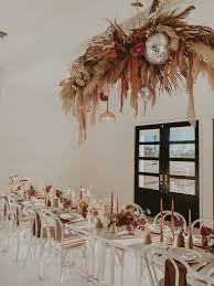 Bohemian Wedding Reception With Dried Florals Tall Candles Ghost Chairs Disco Decorations Bohemian Wedding Reception Summer Wedding Decorations