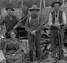 Various Sizes And Shapes Of Brimmed Hats But None Of Them Are The Standard Cowboy Hat Also The Gents Are Buttoned Up T Old West Fantasy Western Old Cowboy