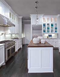 This kitchen features an almost black. White Cabinets Dark Wood Floors Wood Countertop In Walnut On Center Island Wood Countertops Kitchen White Kitchen Remodeling White Modern Kitchen