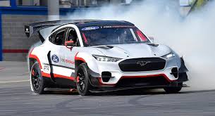 Ford hired british actor idris. Vaughn Gittin Jr Takes Ford Ceo Jim Farley For A Ride In The Mustang Mach E 1400 Carscoops