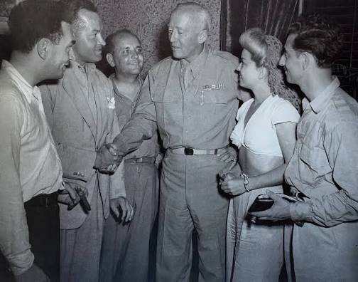 General George S. Patton shakes hands with Bob Hope, joined by Jack Pepper,  Francis Langford, and Tony Romano, as they brought laughter and music to  the troops during WWII. Though Patton was