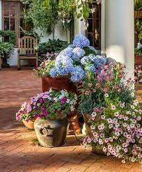 Fake flowers for outside planters. 16 Ways To Use Artificial Flowers In Your Home Mediterranean Landscaping Mediterranean Garden Design Mediterranean Landscape Design