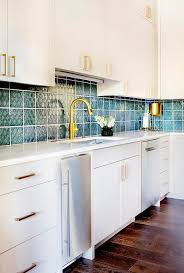 Eye Catching Peacock Blue Backsplash Tiles Complement Light Gray Flat Front Kitchen Cabinets Adorned With Br Blue Backsplash Blue Tile Backsplash Grey Cabinets