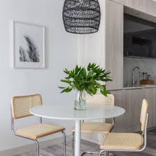 The odyssey dining table amazingly transforms from a 6 person table to a spacious 8 person table with the aid of two rotating boomerang shaped glass. Odyssey White Tulip Dining Table Reviews Cb2 White Round Dining Table Round Dining Table Modern Tulip Dining Table