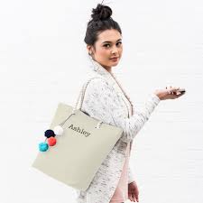 A monogrammed tote bag is a thoughtful bridal party gift, especially if you're doing a destination wedding at a resort or beach retreat; Personalized Cabana Nylon Cotton Blend Beach Tote Bag Natural The Knot Shop