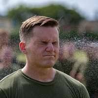 Spc. Logan Lawrence adjusts the Level C suit of U.S.