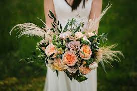A flowershop bouquet of pale pink anthurium and roses, sweet pea, wispy fern, and rice flowers set the tone (literally) for this charleston wedding's wildflowers are the perfect way to embrace your wedding theme. Bouquets Blossom Wedding Flowers
