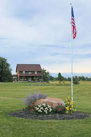 The flagpole should be located in the center of the flat side of the circle, as the landscaping is designed to draw attention to the flagpole. 14 Flag Pole Ideas Flag Pole Landscaping Flag Pole Front Yard Landscaping