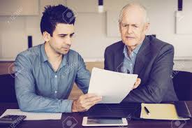 Technology has a significant impact on small businesses, increasing performance and giving smbs access to tools to which they might not otherwise have access. Two Business People Looking Through Document Junior Manager Consulting With Senior Expert Business And Cooperation Concept Stock Photo Picture And Royalty Free Image Image 109071354