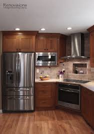 Small kitchen design with cherry wood cabinets. Kitchen Remodel By Renovisions Induction Cooktop Stainless Steel Appliances Cherry Cabinets Shaker C Ic Tasarim Mutfak Luks Mutfaklar Mutfak Ic Dekorasyonu