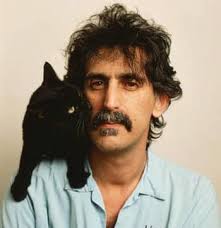 Meow, Clowder! We are honoring cat lover Frank Zappa today! The first photo  is Frank with his cat Marshmoff. Marshmoff posed with Zappa for a purrfect  looking photo shoot. Paws & Purs,