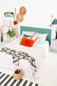 Is the blank wall behind your bed feeling a bit blah? A Clever Do It Yourself Headboard In 60 Minutes Or Less