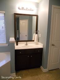 Decorating Cents Framing The Bathroom Mirrors Bathroom Mirror Bathroom Mirror Frame Cabinet Transformations