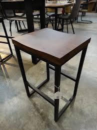 Bar stools are often made of wood or metal. Wood And Metal Stool Features A Metal Frame And Dark Wood Seat