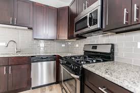 Modern Apartment Kitchen With Dark Cabinets Grey Subway Tile Backsplash Granite Countertops Modern Kitchen Apartment Dark Kitchen Cabinets Apartment Kitchen