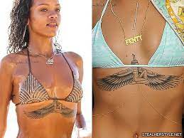 On the right side of her body, rihanna sports an intricately designed. Rihanna S Tattoos Meanings Steal Her Style