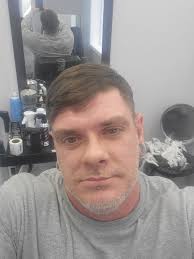 What is the phone number of the barbershop between Dollar General and  Casey's in Boonville?