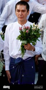 Kim Aris The Son Of Myanmar S Pro Democracy Leader Aung San Suu Kyi Carries Flowers As He Visits The Shwedagon Pagoda In Yangon November 24 2010 Aris The Younger Of Two Sons Of