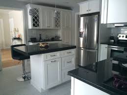 Kitchen cabinets, granite countertops, and quartz countertops. White Cabinets Modern Kitchen Black Granite Countertops Novocom Top