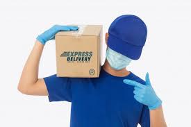 Delivery Man Hand In Medical Gloves And Wearing Mask Holding Cardboard Box Mockup In 2020 Medical Glove Delivery Man Gloves