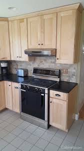 Black And Natural Wood Kitchen Cabinets Small Shaker Kitchen With Natural Stained Cabinets And Black Countertops Cabinets Com Maple Kitchen Cabinets Shaker Style Kitchen Cabinets Maple Kitchen
