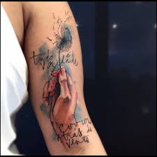 The watercolor tattoos are the new trend which is developing from the last few years in body art. Sketch Watercolor Style Tattoo Of A Hand Holding A