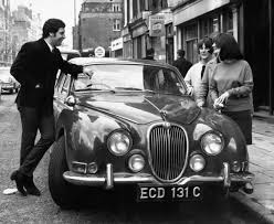 Welsh singing star Tom Jones shows off his new Jaguar car