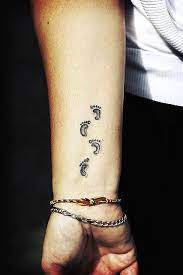 Tiny footprints, etched on the wrist, look cute and remind you of the little angel in your life. Pin On I Love Tattoos