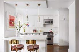 Small Mini Glass Brass Pendant Lights Over Kitchen Peninsula White Kitchen White Modern Kitchen Kitchen Peninsula