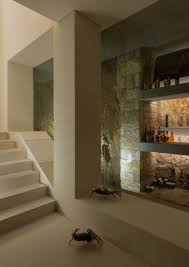 Get a free basement design consultation today. Ultra Modern Basement With Real Stone Walls Cement Floors Walls A Built In Bar Modern Basement Modern Flooring Ultra Modern Homes