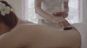 Young woman having hot stone massage in spa 1806397 Stock Video at Vecteezy