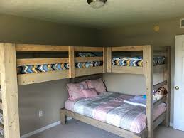 Stylish industrial bunk beds of metal and wood, with wall lamps and ladders to reach each upper bed. Conserving Space And Staying Trendy With Triple Bunk Beds Triplebunkbeds Bedroom Bunkbed Homedecor Diy Bunk Bed Kids Loft Beds Bunk Bed Designs