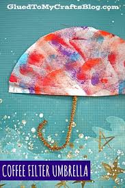 We painted these mini umbrellas with sponges to get a textured effect! Coffee Filter Umbrellas Kid Craft Idea For A Rainy Day